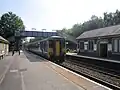 A Northern Rail Class 156 waits at the station.