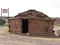 Gas station sign behind a building on Fort Courage
