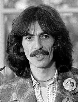 A man with long hair and a mustache