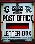 A close-up of the enamel plate on a GR Ludlow box.