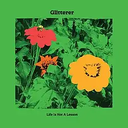 A green graphic with three bright flowers