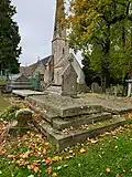 Photograph of the grave of Louisa Cooke, née Hardy, with St&nbsp;Peter's Church, Leckhampton, shown in the background