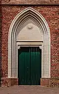 Side entrance with memorial plaque.