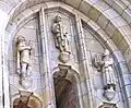 Bernlef (left) on the façade of a church holding his harp, sculpted by Willem Valk&nbsp;[nl; ca] in 1940[14]