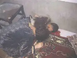 The bloody bodies of Asmaa Salman Raseef (32) and her son Abdullah (4). Asmaa's body can be seen holding her son, who was shot in the head.