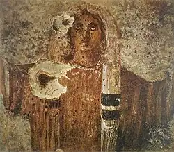 Stage two, the girl becomes a consecrated virgin, praying in the orante-style pose.[15]