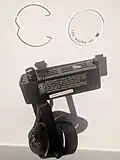 An H-track fixture head with integrated transformer, showing 2 of the 3 contacts on the same side. Model No. Hampton Bay EC762.
