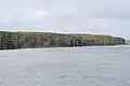 Cliffs and chambered cairn on Helliar Holm.