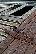 Rusty hinges on a building exterior.