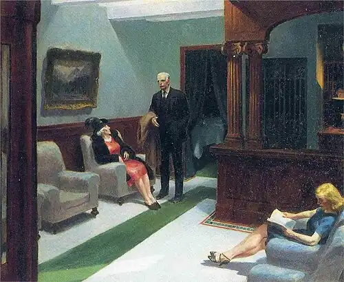 A man and two women sit in a hotel lobby with stark lighting and subdued tones