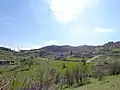 Village landscape under bright skies, viewed from the east