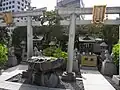 Two small Inari shrine with two foxes guarding each fronts