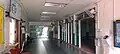 The main hallway of the mosque, with the entrance to the prayer hall visible on the right and the customer service office on the left.