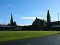 The setting of the Grannie Stone with F. T. Pilkington's 1863 Trinity church to the left and the former Wilson Fullarton Free church to the right[13]