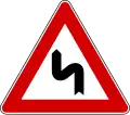 Double bend, first to the left (also used )