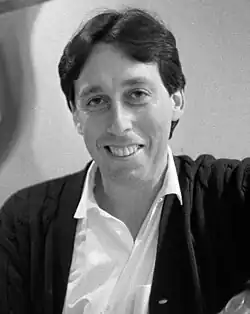 Photograph of director Ivan Reitman at a red carpet event with photographers behind him
