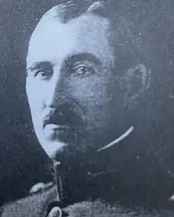 Black and white head and neck photo of John William Barker in dress uniform, facing right, looking lightly left