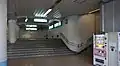 The stairs leading from the ground-level Daishi Line platforms to the elevated Keikyu Main Line platforms (4 to 7) in January 2016