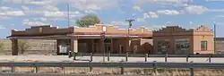 Low brick building with large brick awning