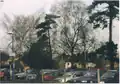 King's Sutton village, as seen from the station in 2000. The chain-link fence was replaced in 2009.