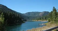 A large river flowing through forested hills