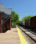 A freight train passes through Laurel station.