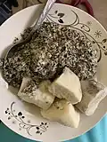 Ndolé served with manioc (cassava) on the side