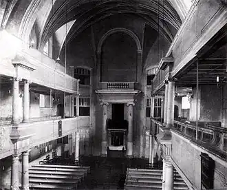 Peterskirche, black-and-white view of the interior toward the altar, showing a vaulted roof and two tiers both right and left