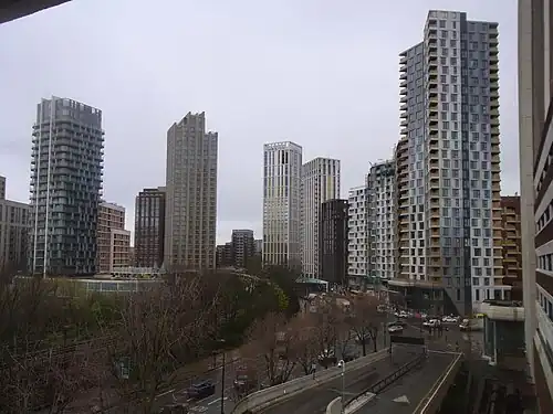 The emerging cluster in Lewisham also known as Lewisham Gateway, and first Borough of Sanctuary,[513] which includes 209 Connington Road Tower at 117m tall which is the white building in the centre and Lewisham Exchange at 105m tall to the left of it. All of the high-rises shown in this picture are residential with the exception of the grey building shown in the immediate right foreground which was formerly the London offices of Citigroup until they relocated to 25 Canada Square at Canary Wharf in 2001