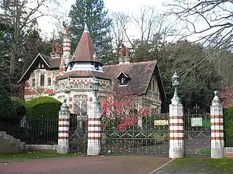 Stone gatehouse with Gothic Revival architecture and pointed tower roofs