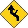 W1-10dL Reverse curve with side road (left)