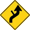 W1-10dR Reverse curve with side road (right)