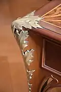 Decoration of a thistle leaf on a desk corner.