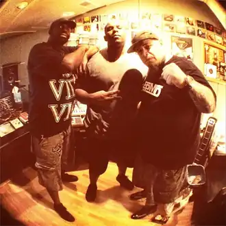 Arnell (center) with Malik B. (left) and Vinnie Paz in 2014