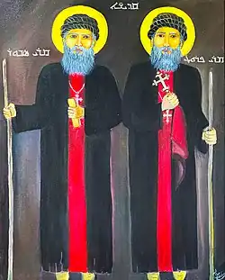 Two bearded holy men, holding staffs