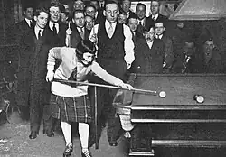 Margaret Lennan playing English billiards with an audience watching