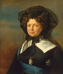 Portrait of a dark-haired ageing woman dressed in black, wearing a black veil, a blue riband and a star of the Order of Saint Andrew, and a medallion with the profile of tsar Paul. It was painted in the year of the interregnum.