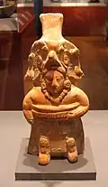 The yoke and kneepads identify this molded ceramic figurine as a ballplayer. Like many, it also functions as a whistle. 600–900 AD.