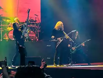 A four-piece band performing onstage