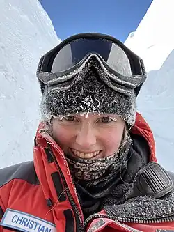 Portrait photograph of Meganne Christian in the snow, at Concordia Station, Antarctica. Icicles on clothing.