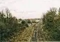 The carriage sidings (left after the metal fencing) are now out of use and partly removed (part lifted).