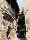 The raised passage linking the main building (right) and the annex (left). The annex consists of a hod (water trough for animals) on the ground floor and a kuttab (school) on the upper level.