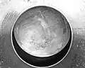Hollow steel ball serving as a blast valve for the ventilating system of a hardened shelter.
