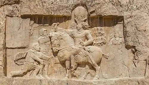 Rock relief at Naqsh-e Rustam; the Persian Sassanian emperor Shapur&nbsp;I (on horseback) with Roman emperors submitting to him