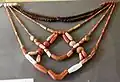Necklaces with different types of beads. Carnelian, coral, and garnet.