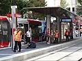 Tram at a light rail stop on the street