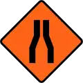Road narrows on both sides