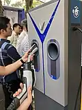 SAE J1772 plugs operated by thumb at a VinFast charging station