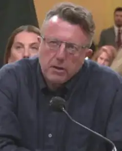 A photograph of Nick Quested testifying before the United States House of Representatives Select Committee to Investigate the January 6th Attack on the United States Capitol