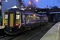 A Northern Rail Class 156 waits at the station.